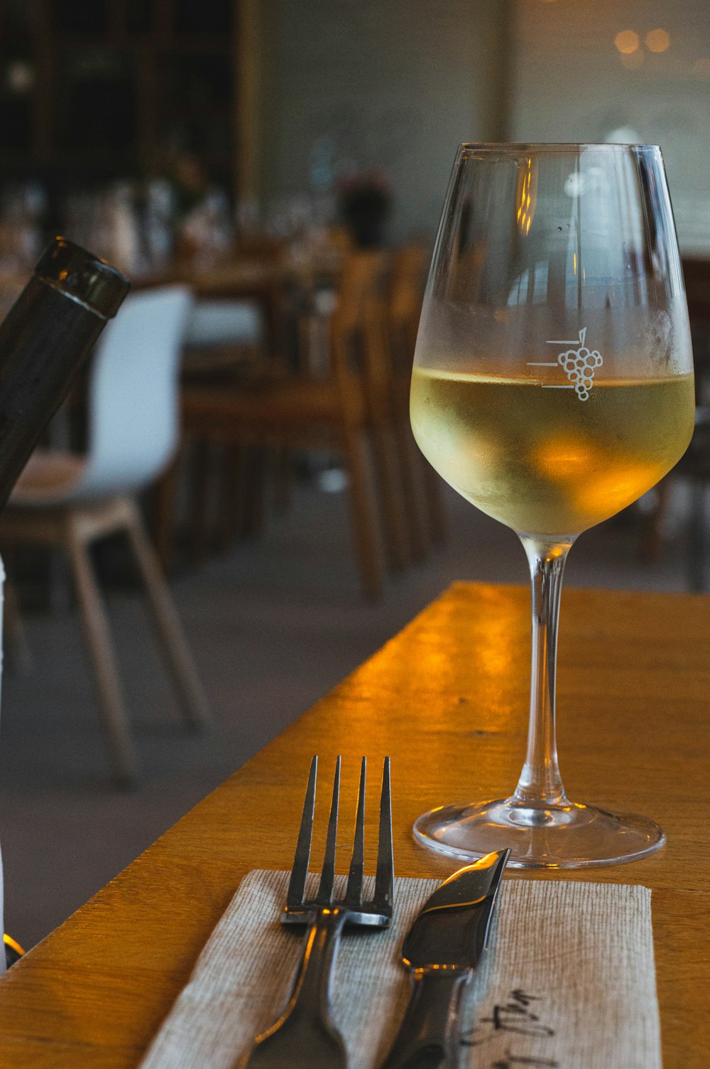 a glass of wine sitting on top of a wooden table