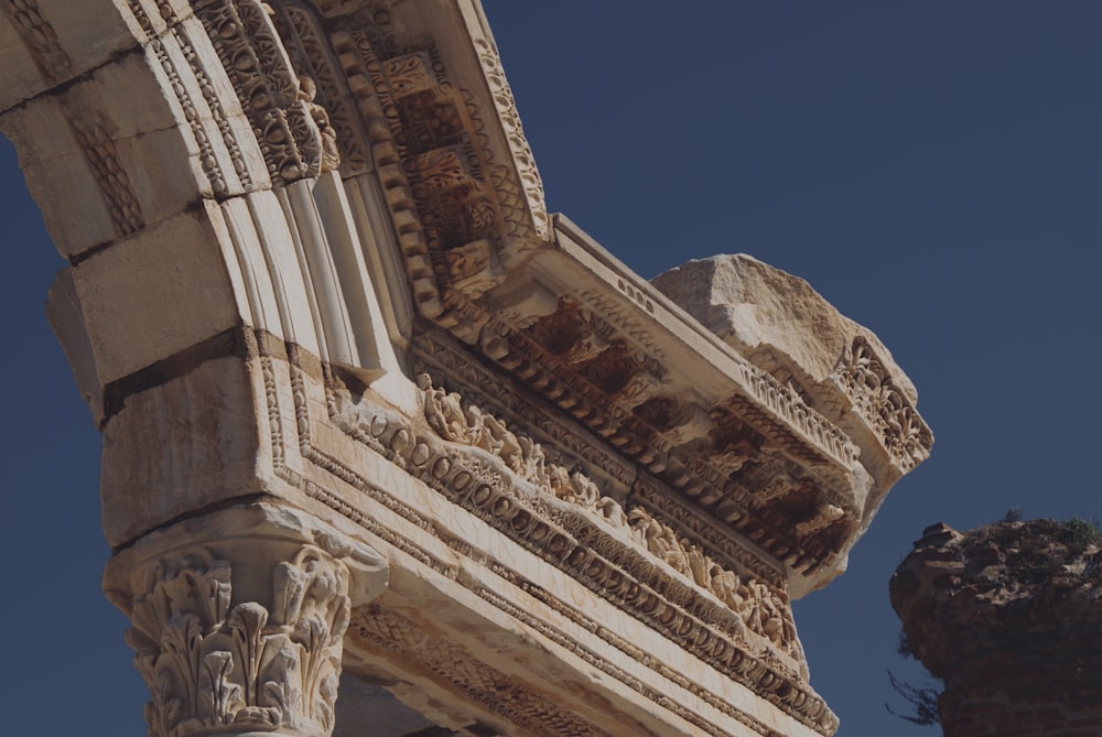 a close up of a stone structure with a sky background