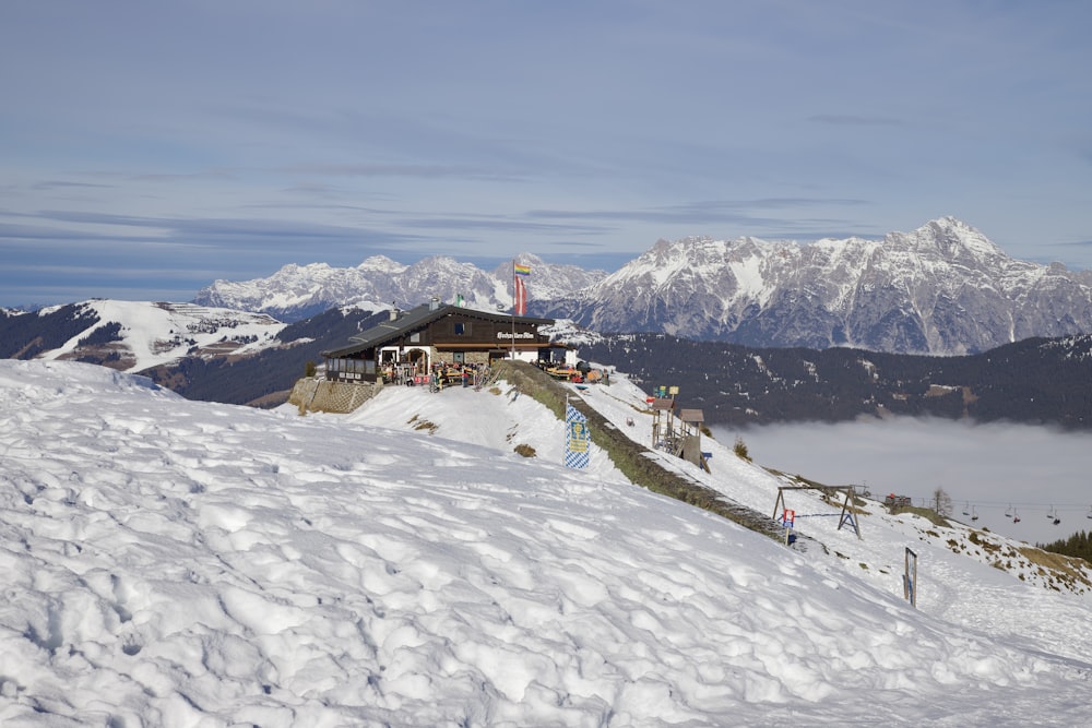 a snow covered hill with a building on top of it