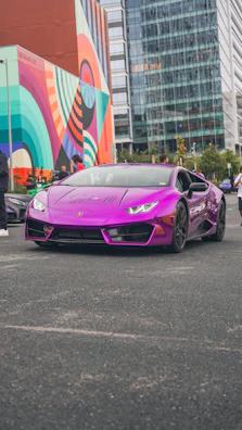A luxury convertible parked by a famous Montreal mural, blending art and prestige.