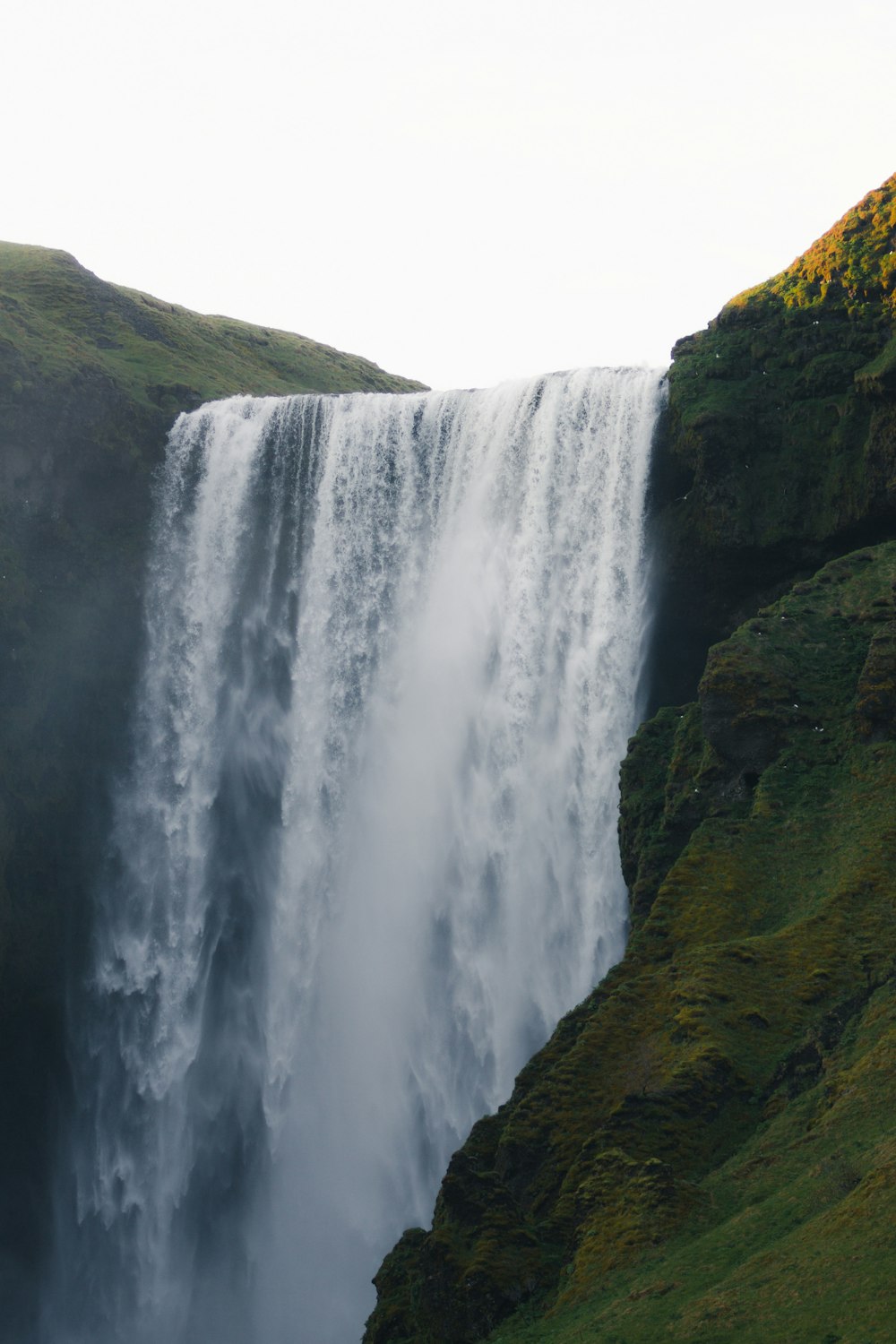 a large waterfall with water cascading down it's sides