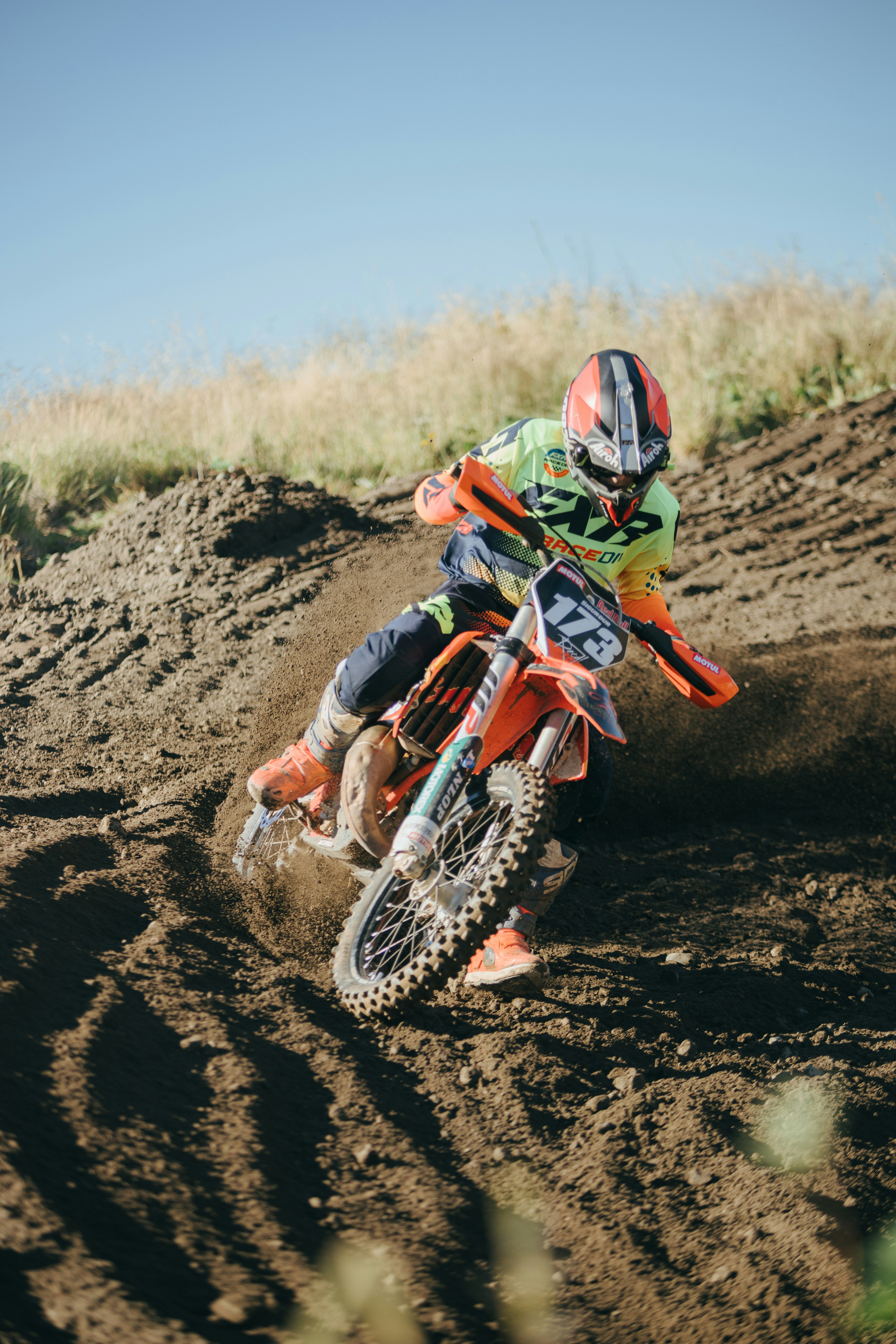 a man riding a dirt bike on top of a dirt field