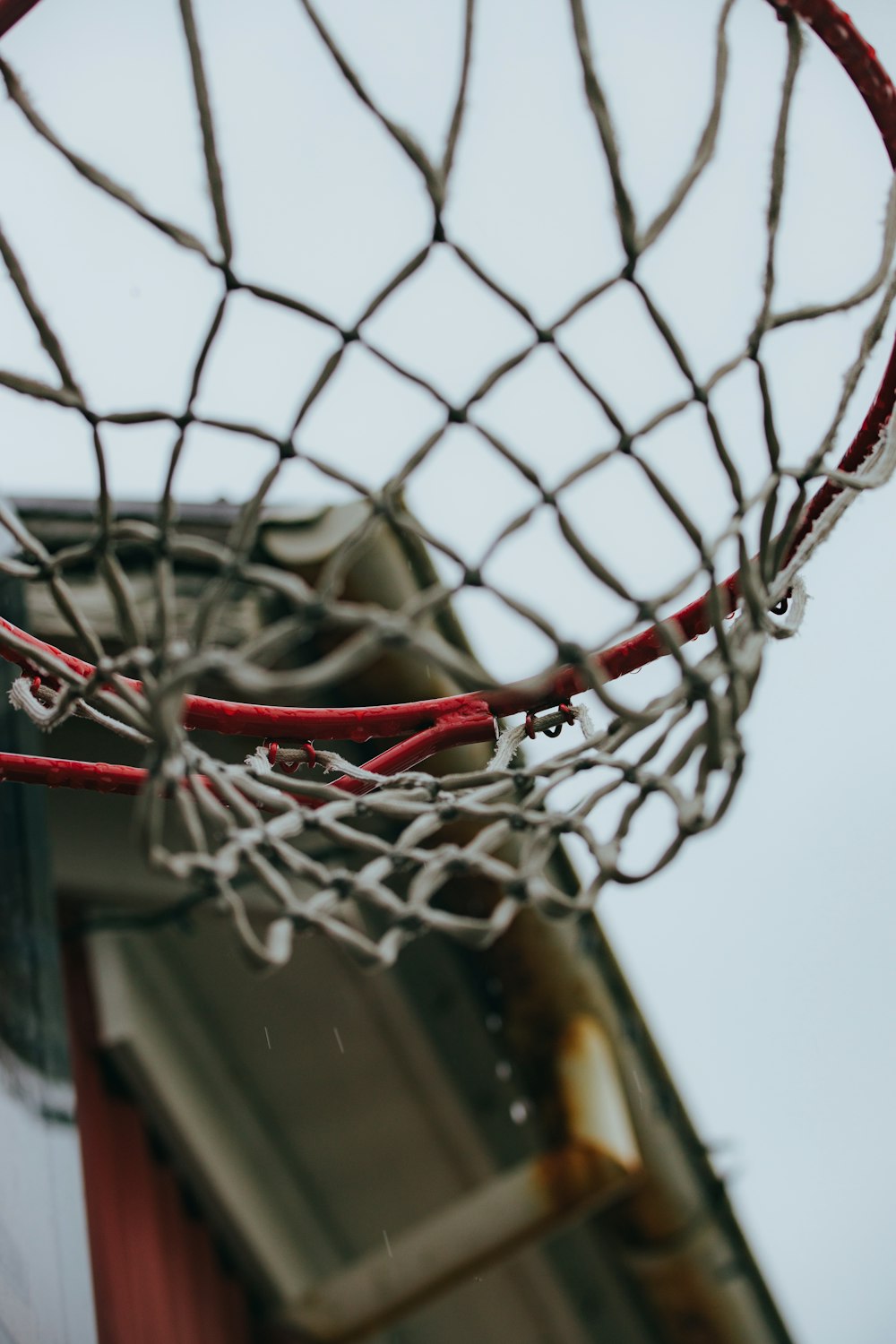 a close up of a basketball net with a building in the background