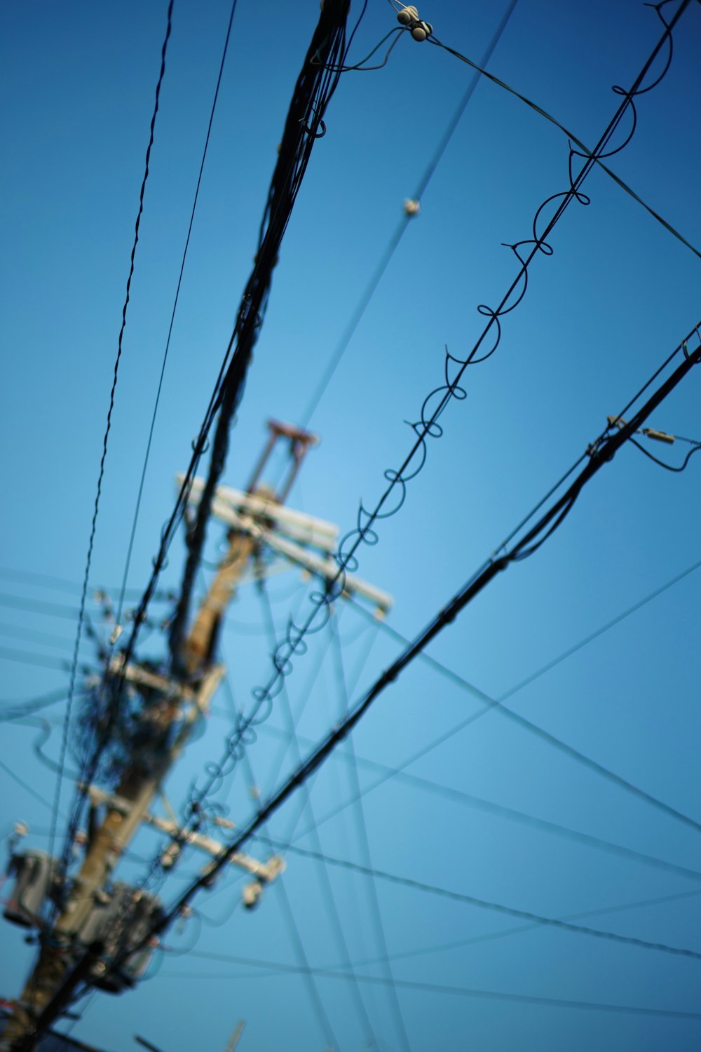 a telephone pole with a lot of wires on top of it