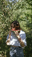 Happy person enjoying a healthy fruit mix outdoors in natural sunlight