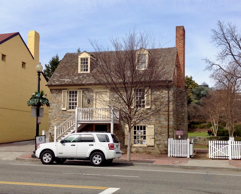 a white truck parked in front of a house