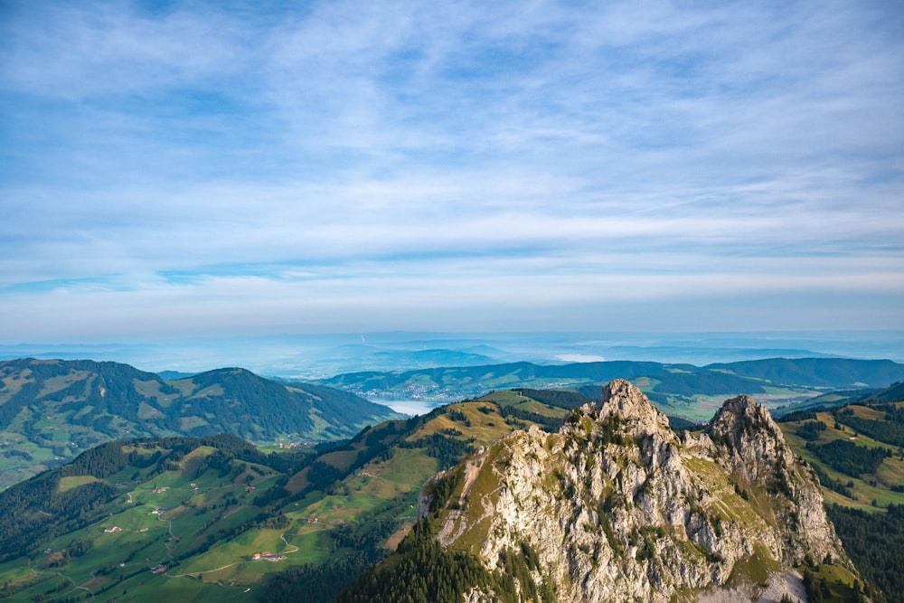 a view of a mountain range from the top of a hill