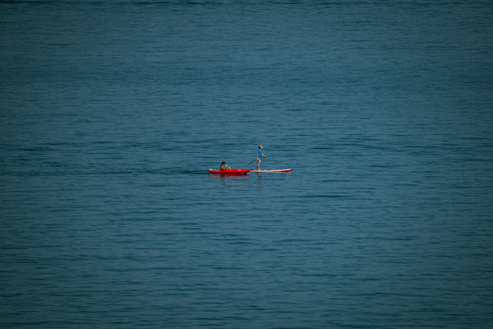 a person paddling a boat in the middle of the ocean