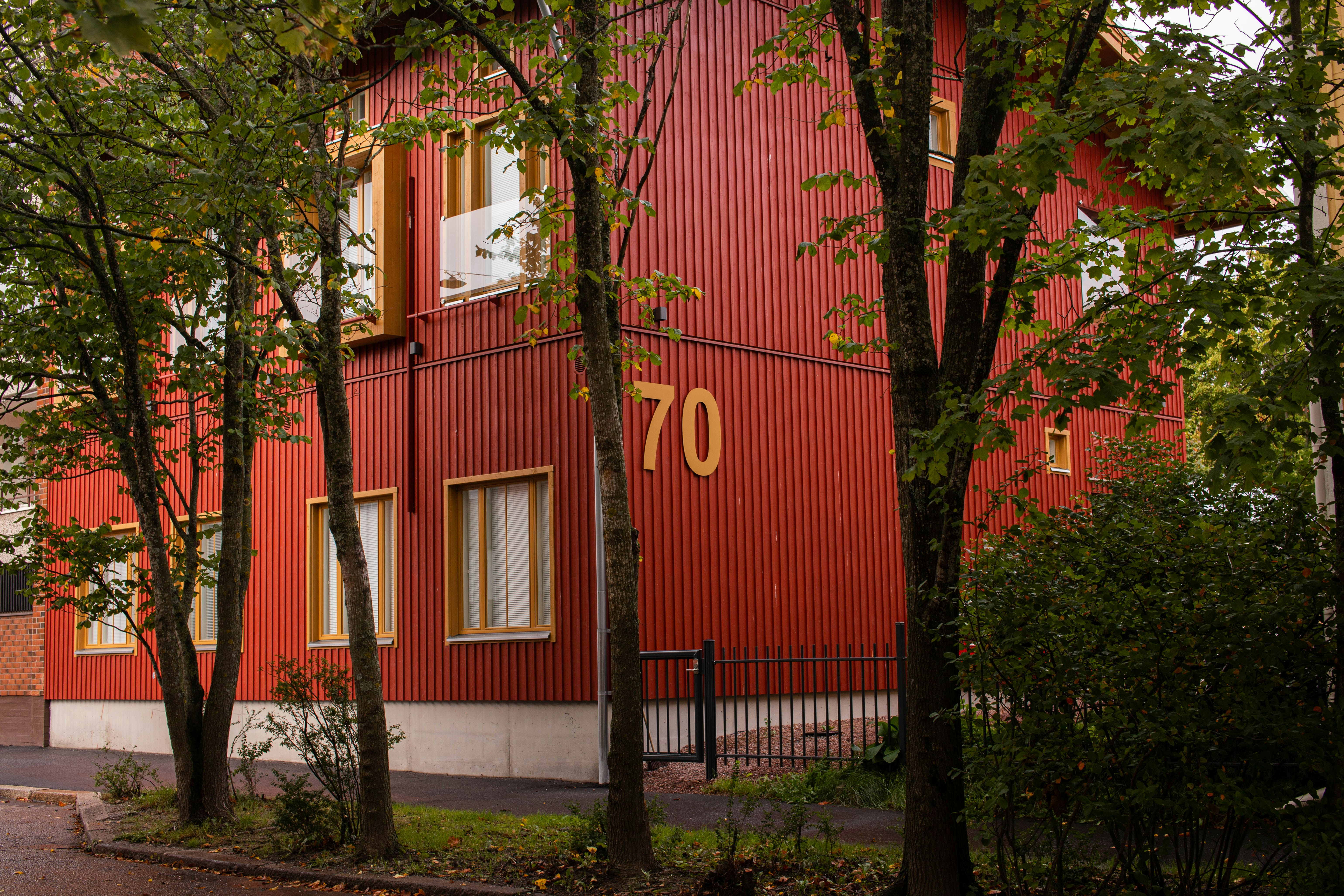 a red building with a clock on the side of it