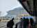 Happy Brazilian man with suitcase at a cruise terminal, ready to board.