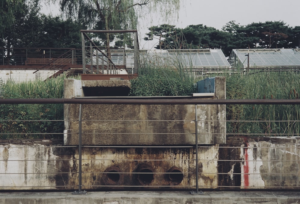 a concrete structure with a metal fence around it