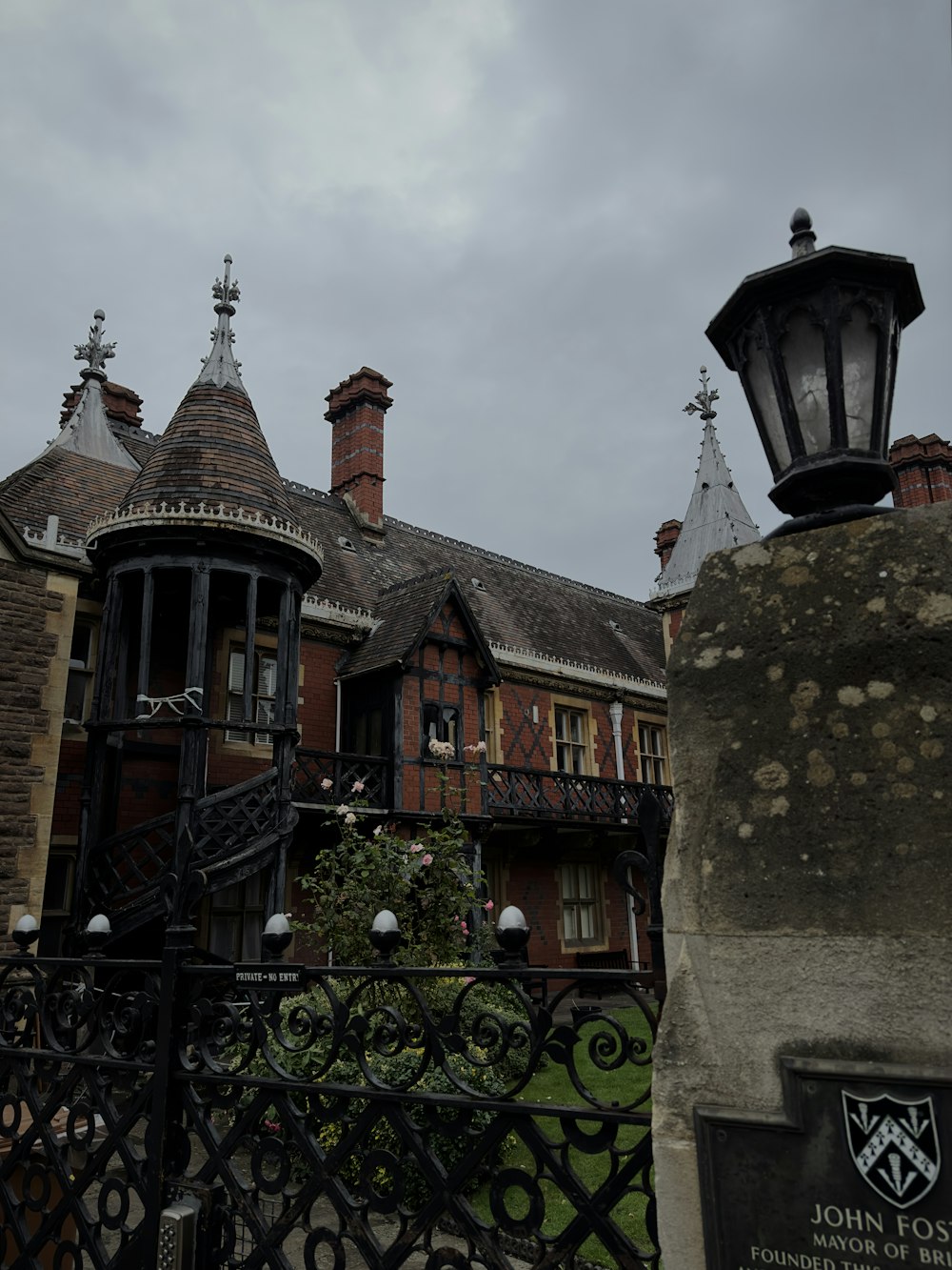 a building with a gate and a light on top of it