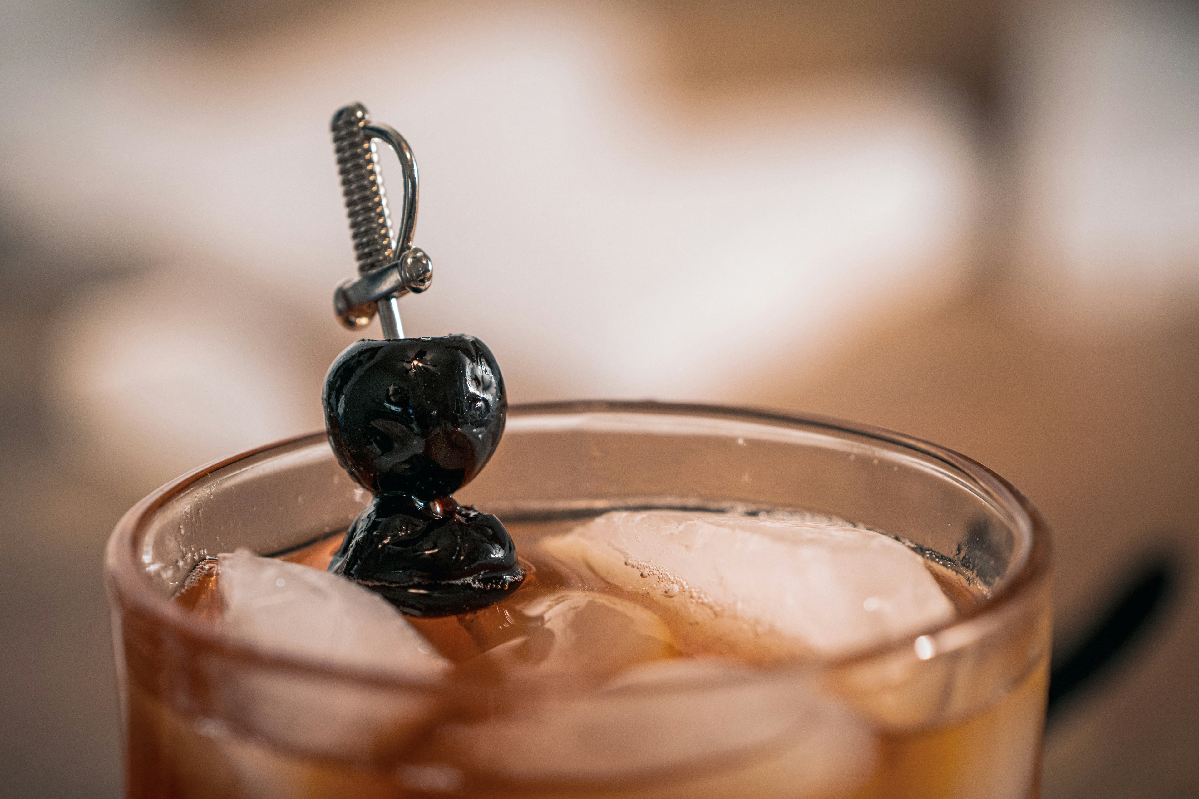 a glass filled with ice and a black bear on top of it