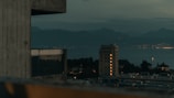 Still from a cinematic short film showing a dramatic urban landscape at dusk.