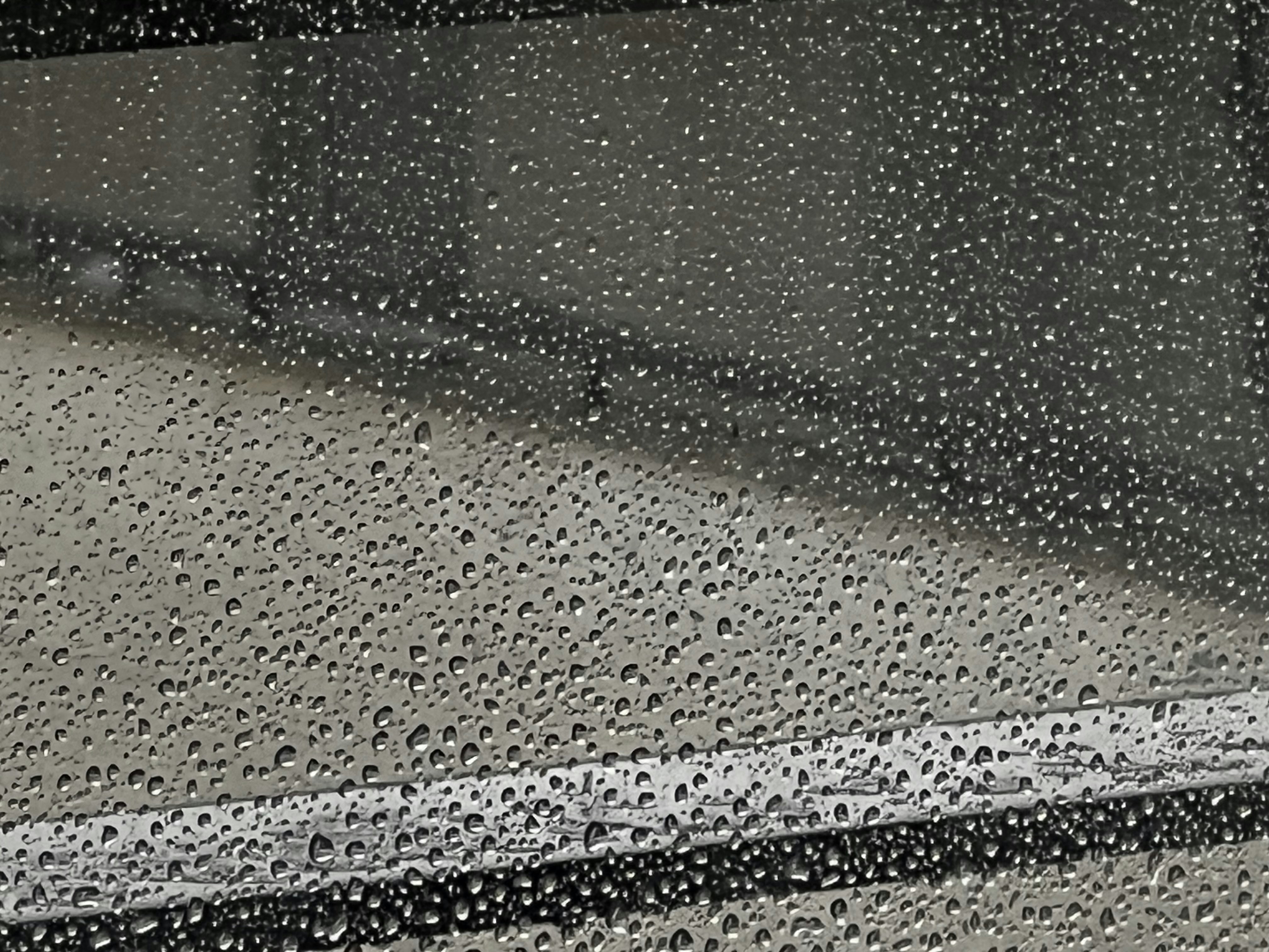 a close up of a window with rain drops on it