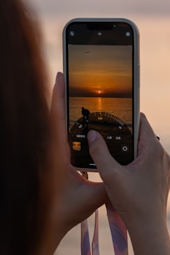 User recording a sailing route on Navipro app at sunset.
