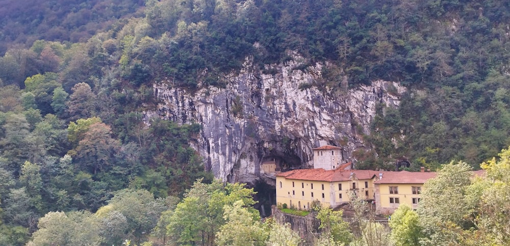 a large building sitting on top of a lush green hillside