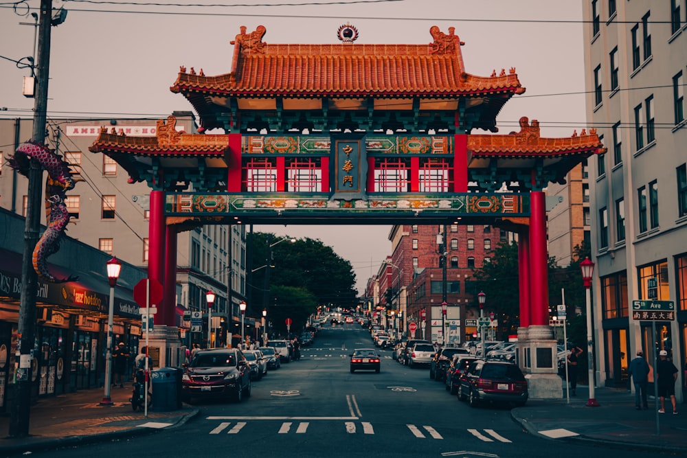 a street with a red gate and cars on it