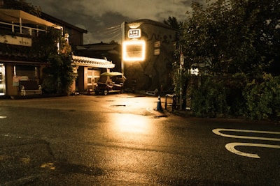 An eerie, dimly lit street corner bathed in neon glow, reminiscent of David Lynch's style.
