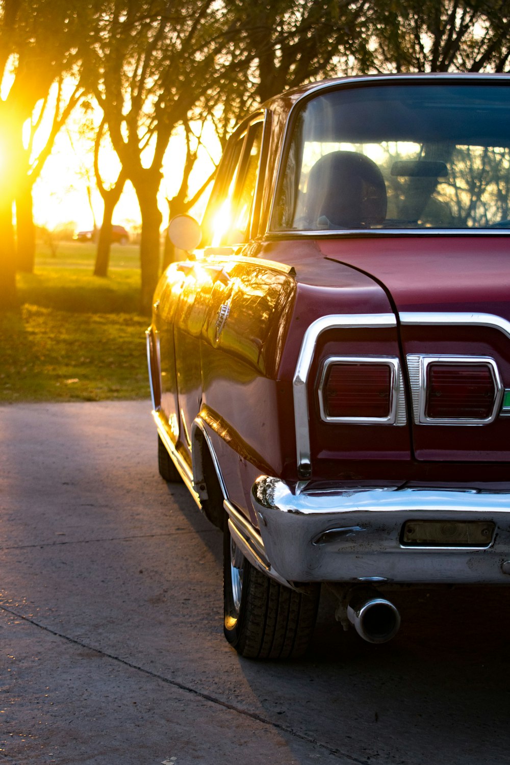 a red pickup truck parked on the side of a road