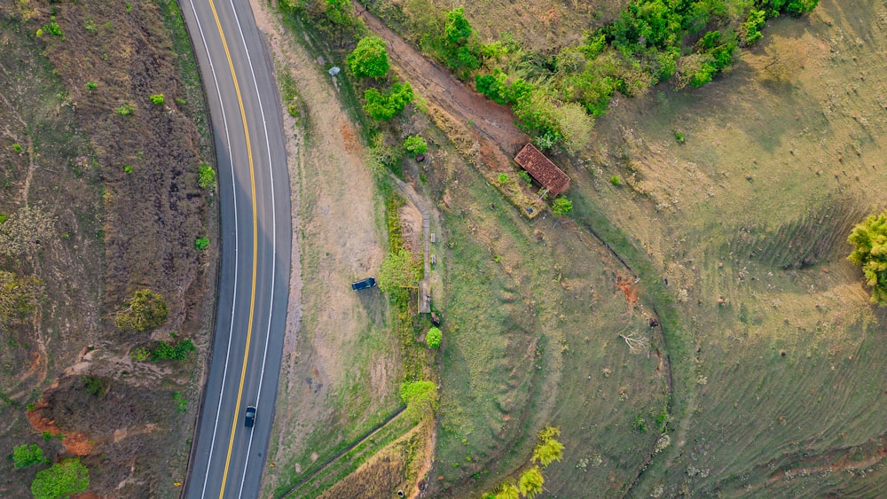 an aerial view of a road in the middle of a field