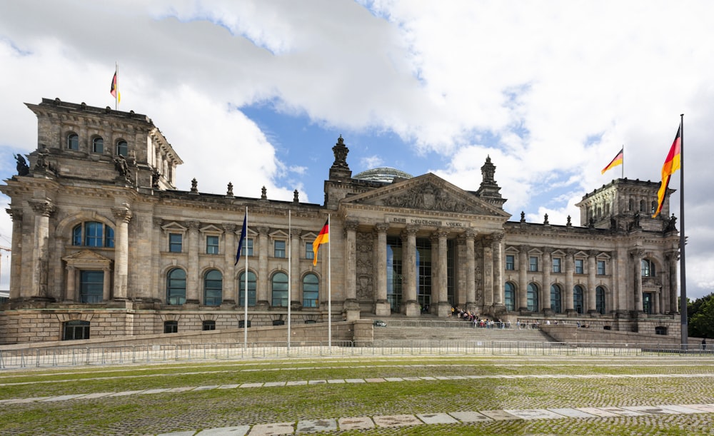 a large building with flags flying in front of it