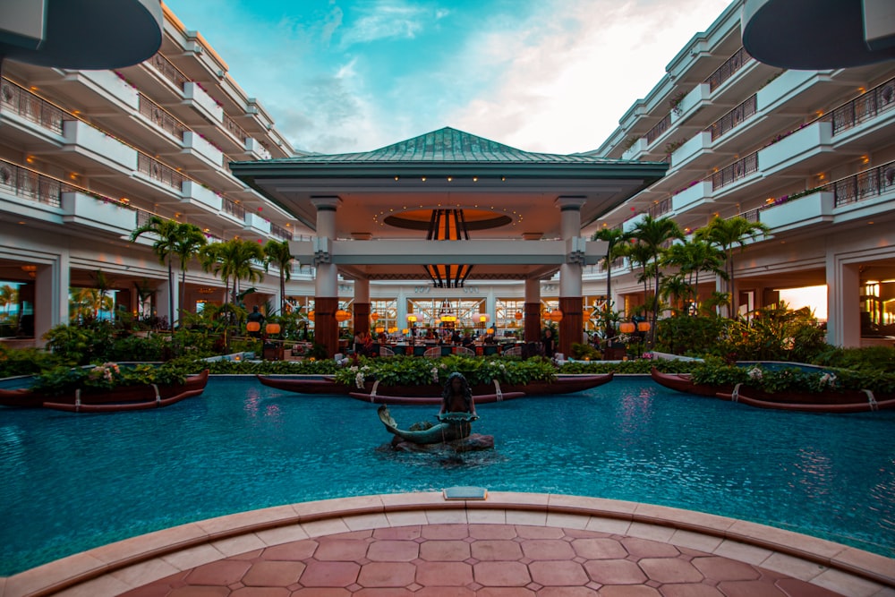 a hotel lobby with a pool and a fountain