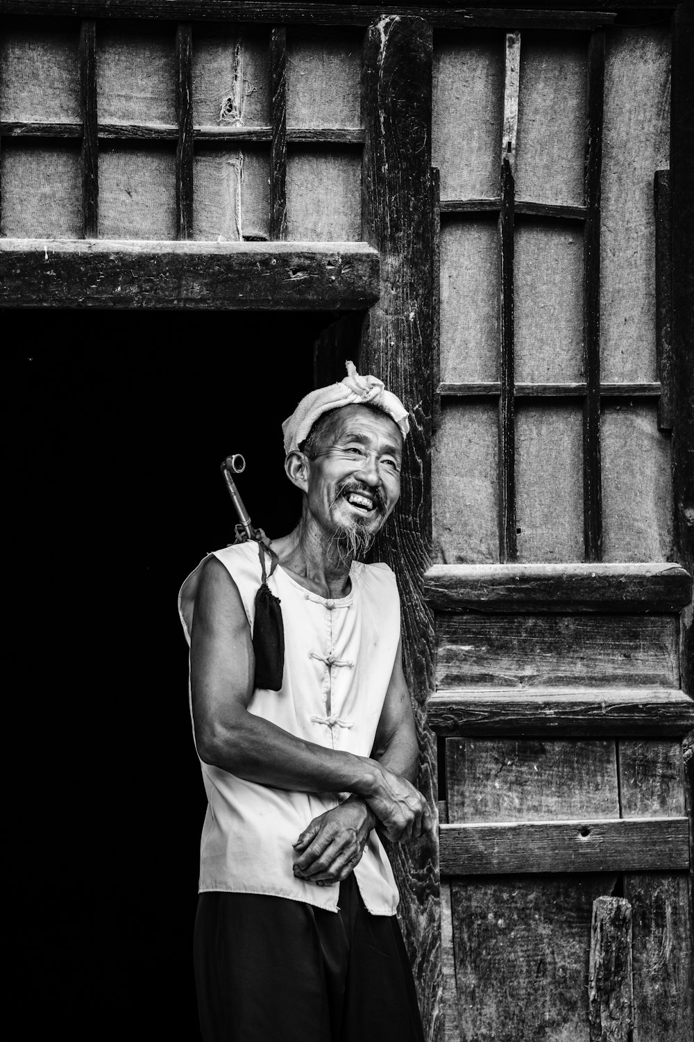 a black and white photo of a smiling man