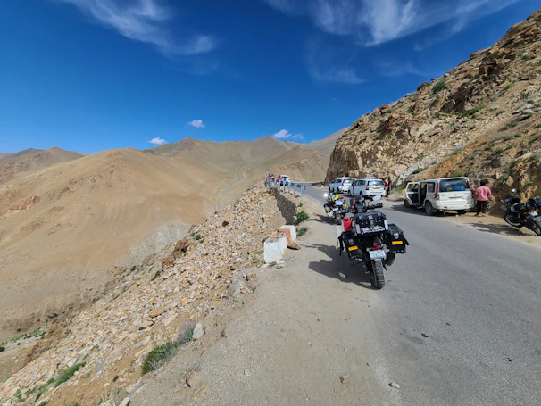 Drivers and guests sharing stories and laughter during a scenic stop, surrounded by rolling hills.
