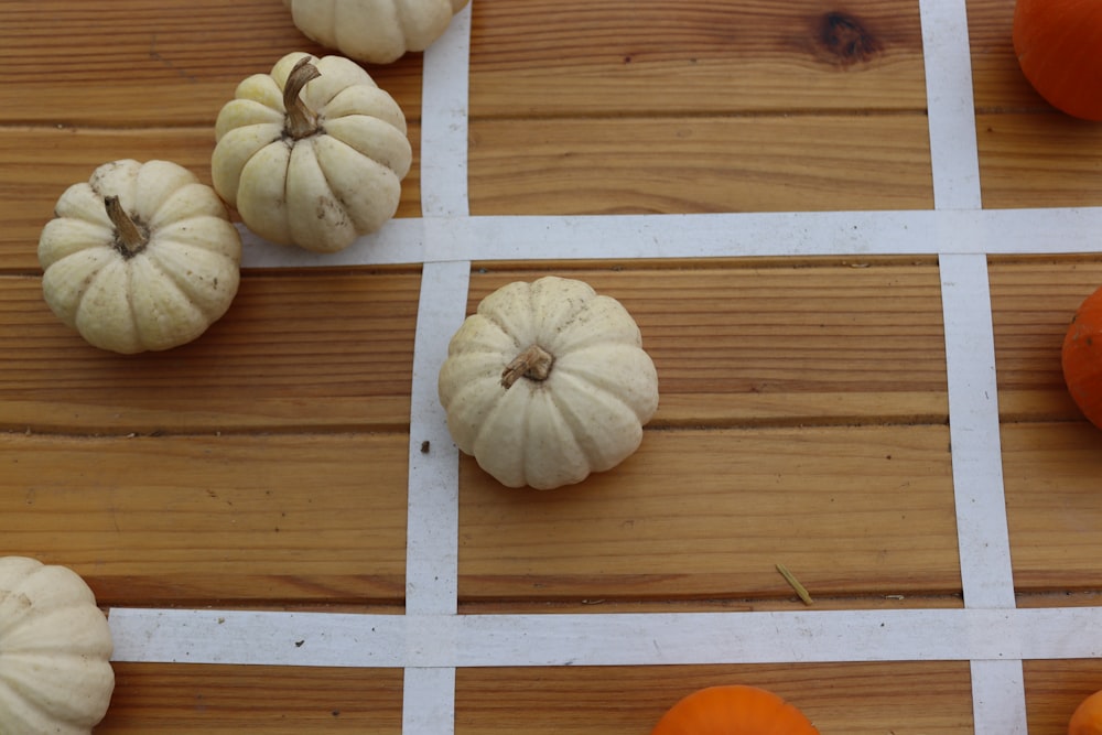 a group of pumpkins sitting on top of a wooden table
