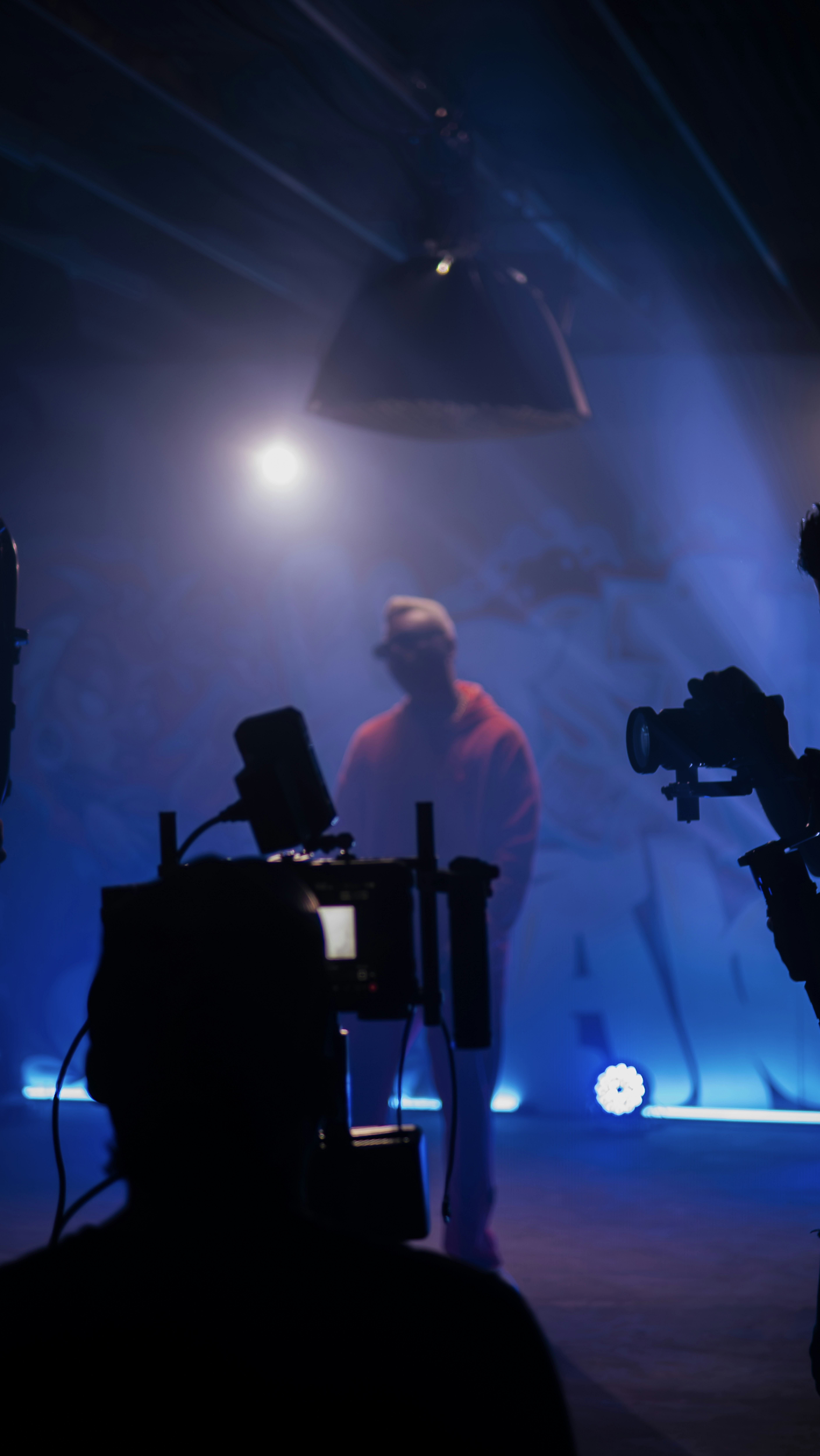 a man standing in front of a camera on a stage