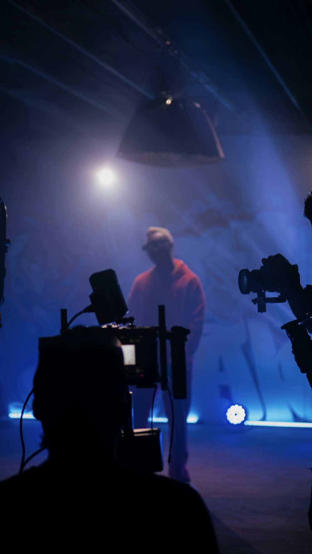 a man standing in front of a camera on a stage