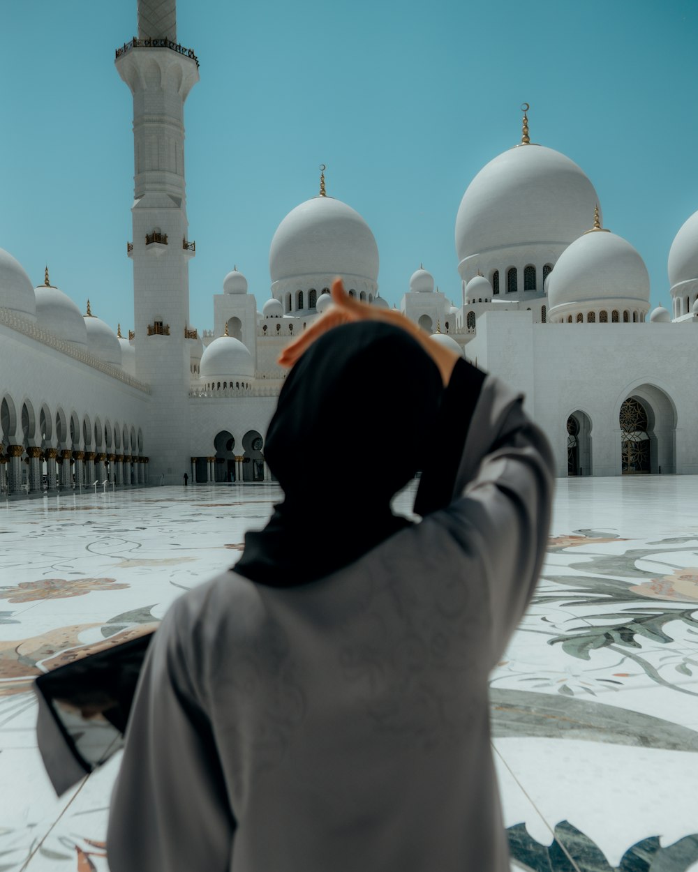 a person standing in front of a white building