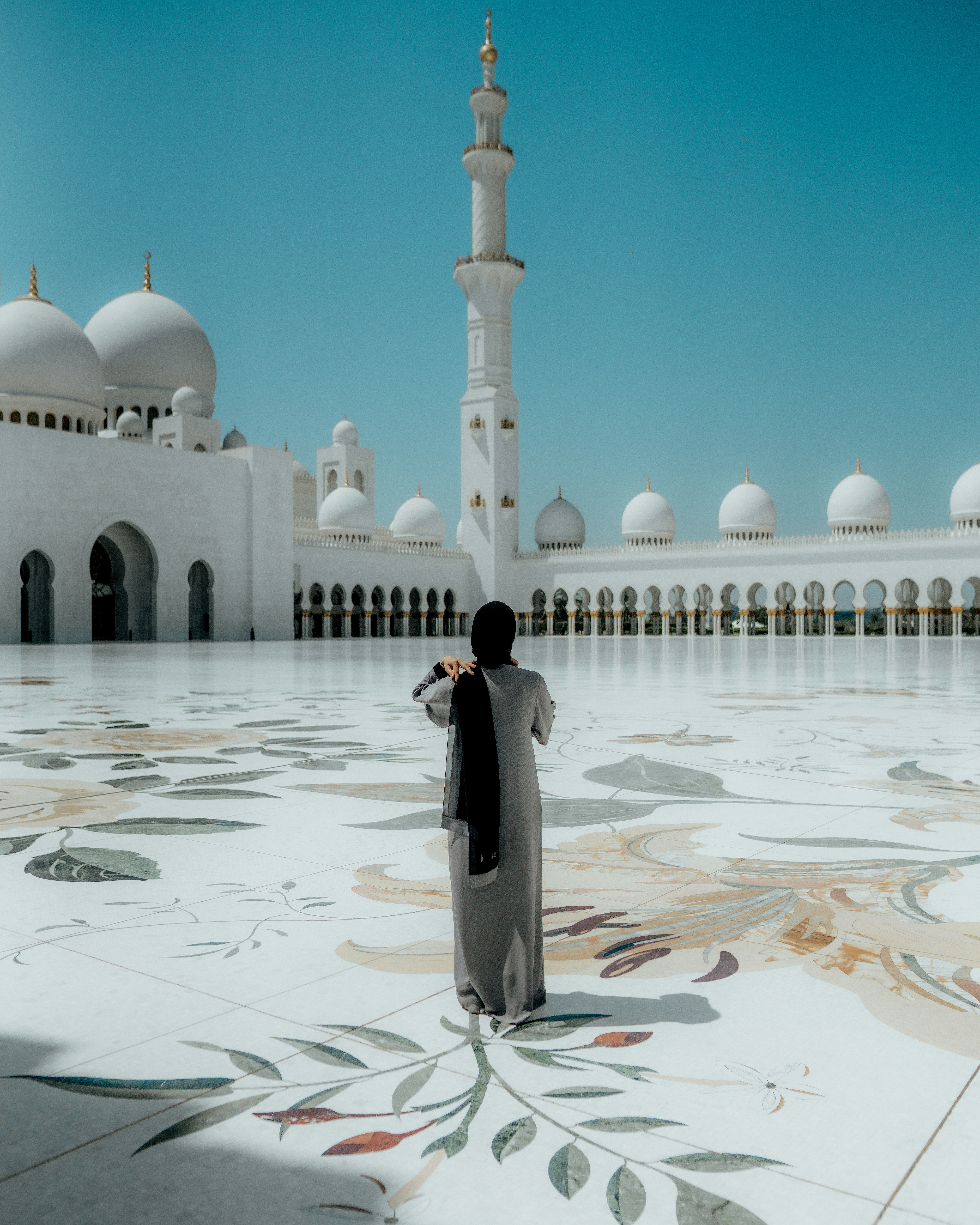 a person standing in front of a white building