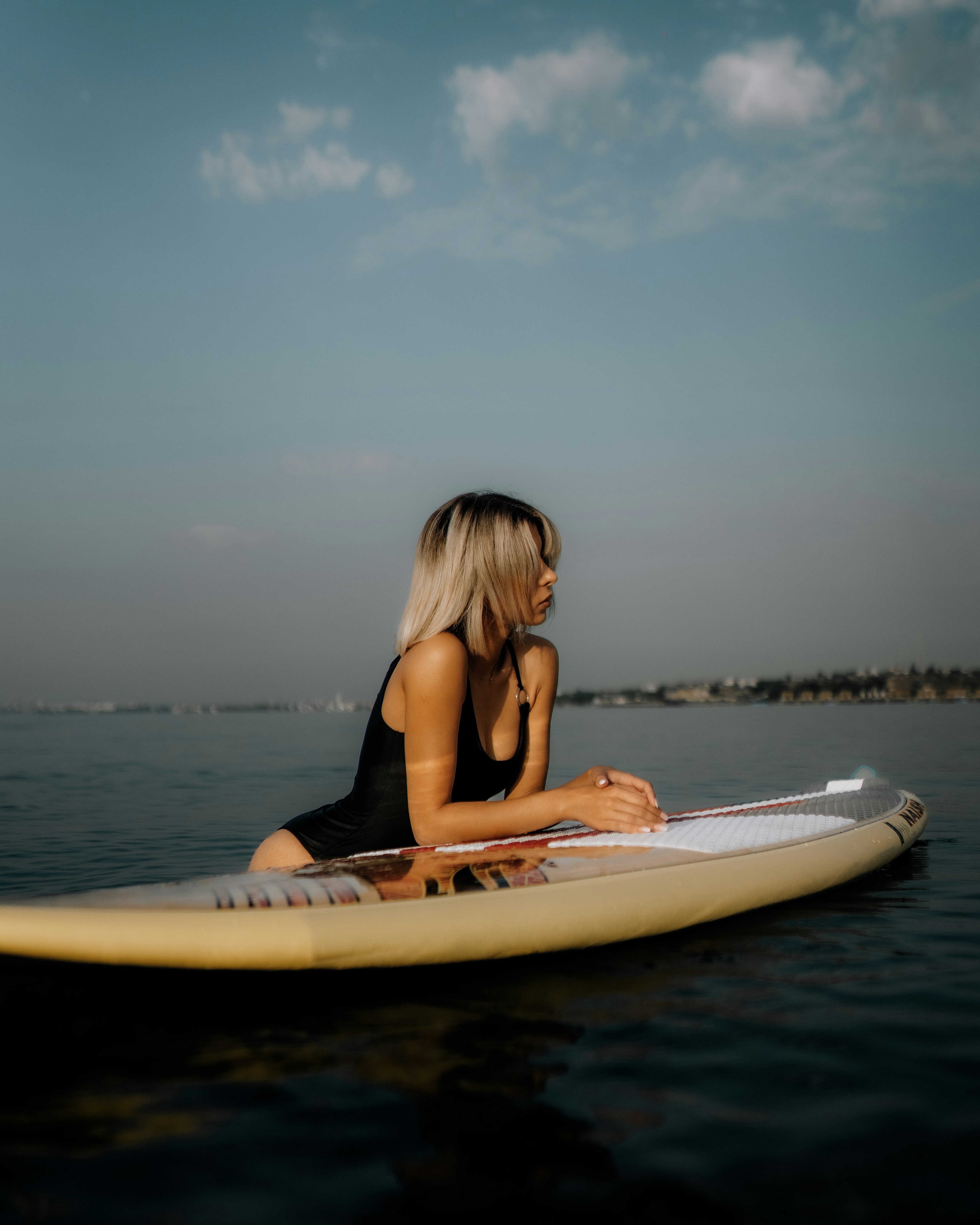 a woman sitting on a surfboard in the water