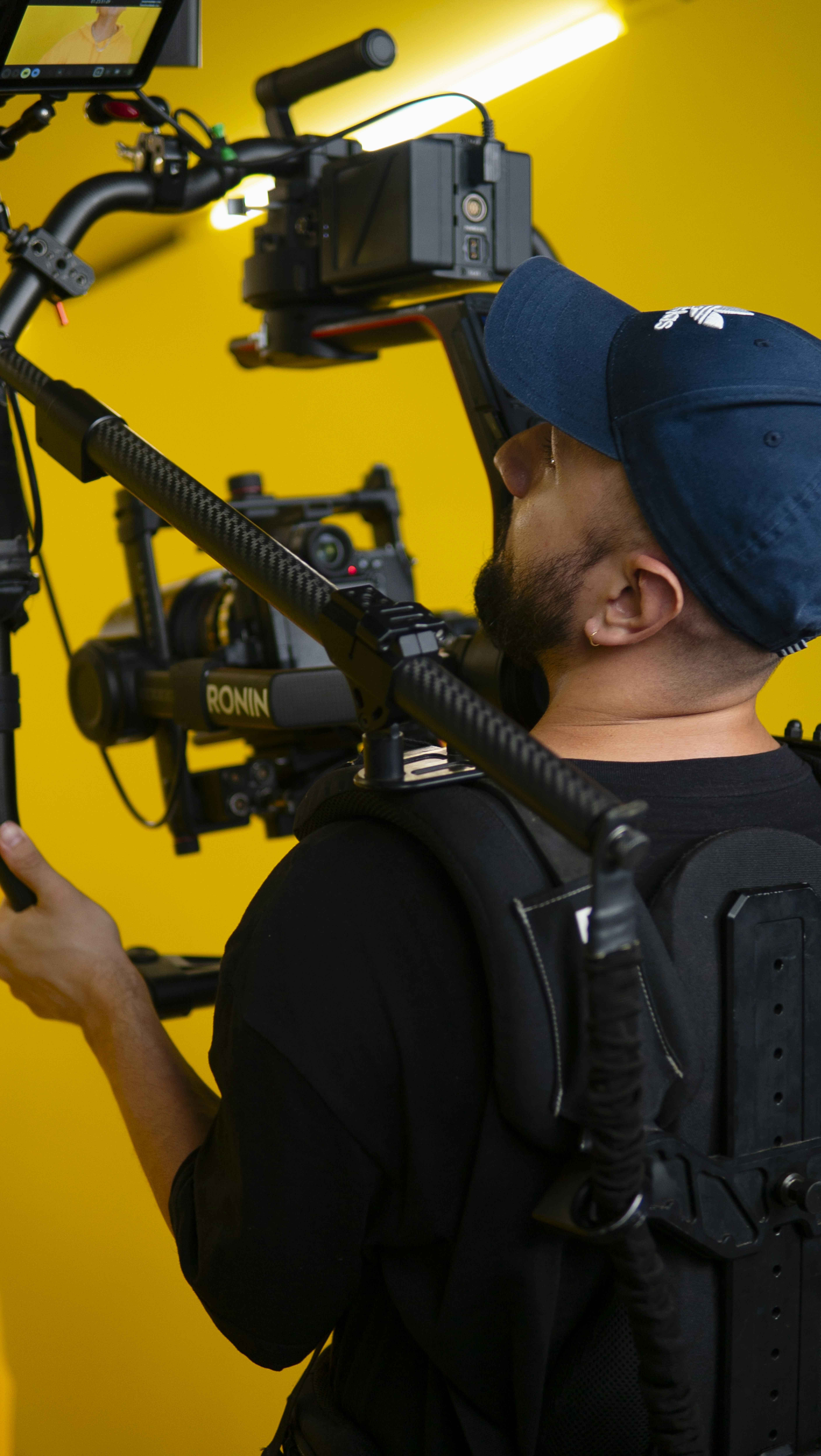 a man in a blue hat is holding a camera