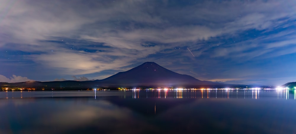 a large body of water with a mountain in the background