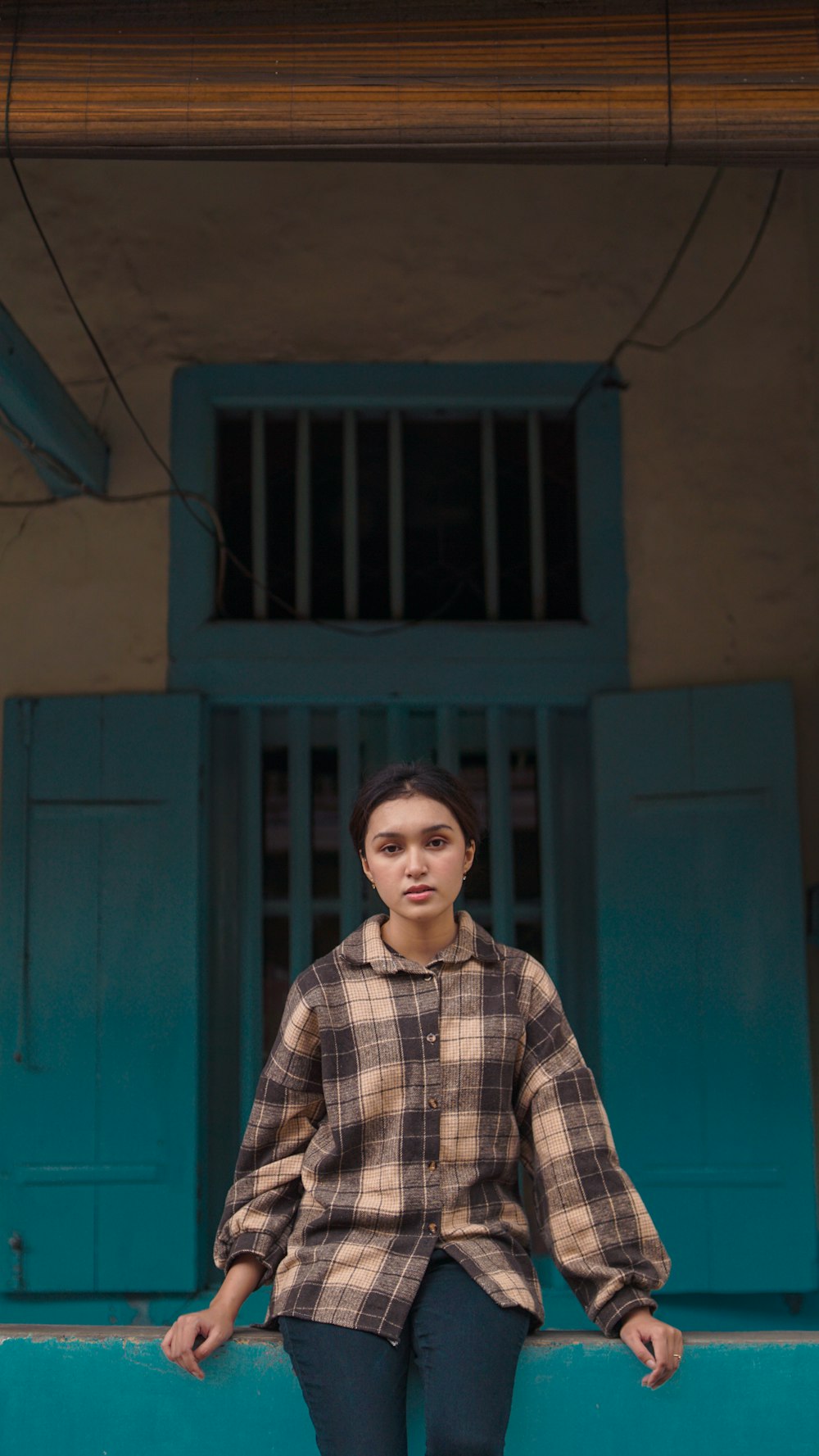 a woman standing in front of a blue door