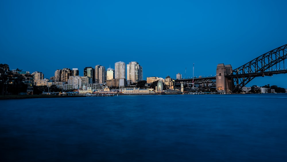 a city skyline with a bridge in the foreground