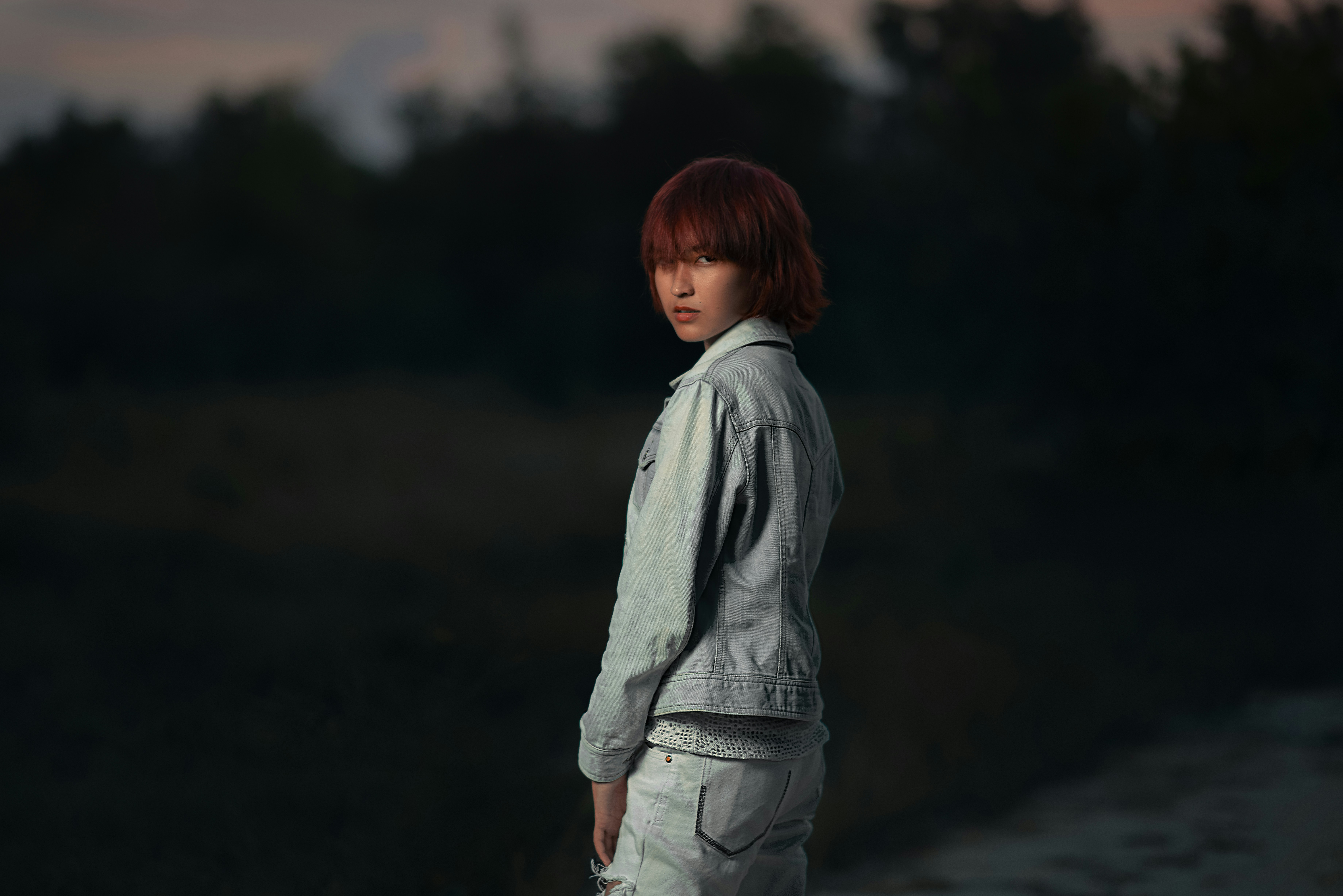 A woman with red hair standing in a field photo – Free Sunset Image on ...