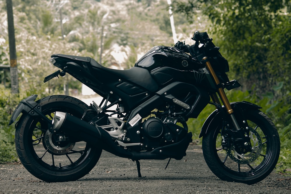 a black motorcycle parked on the side of a road