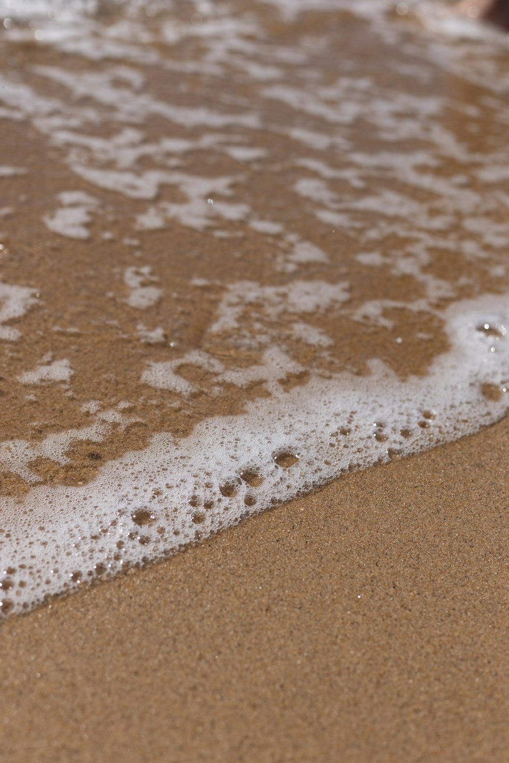 a close up of a wave on a beach