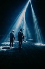 a couple of people that are standing in the dark