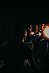 a person sitting in front of a television in the dark