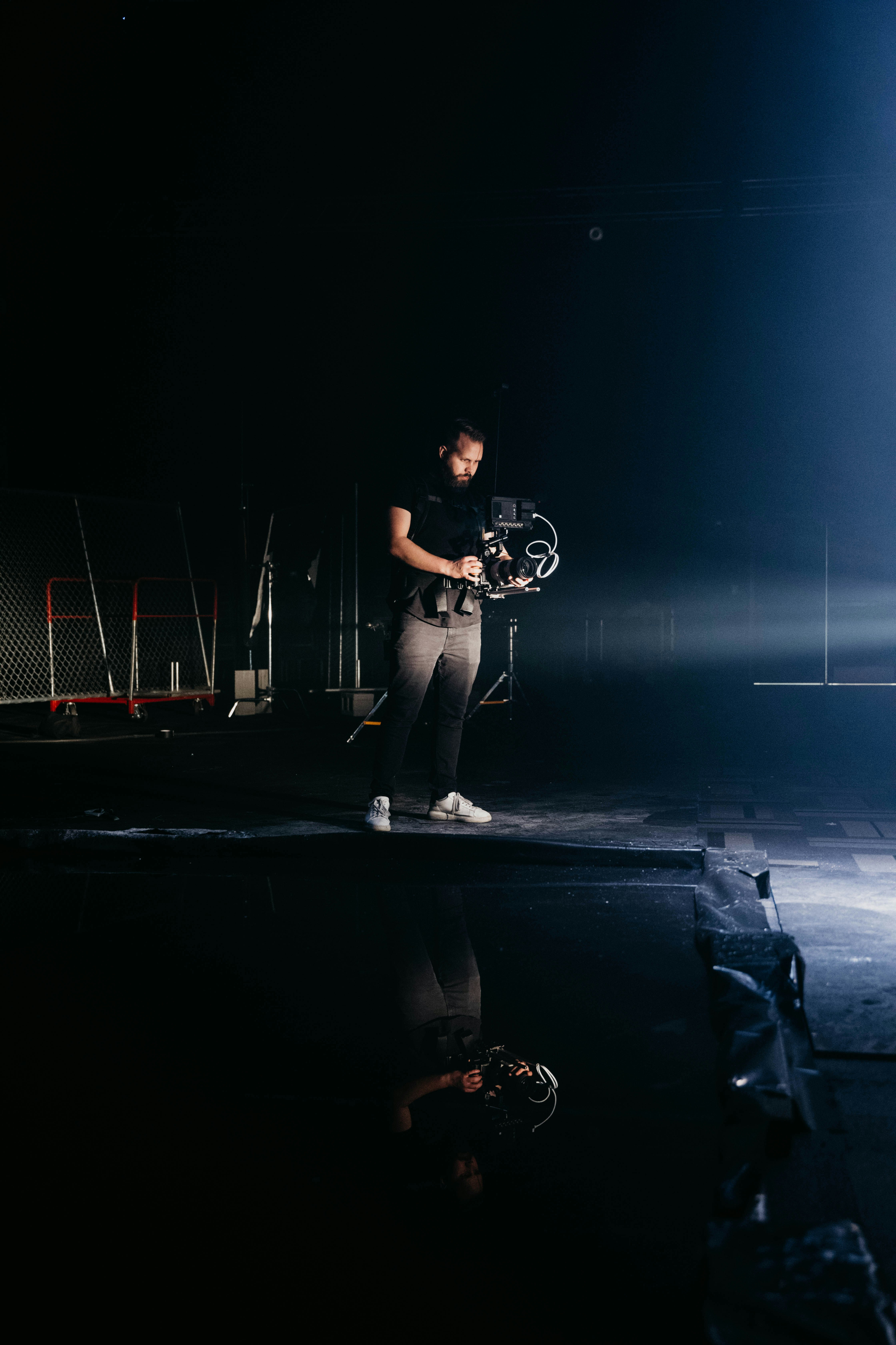 a man standing on a stage holding a camera