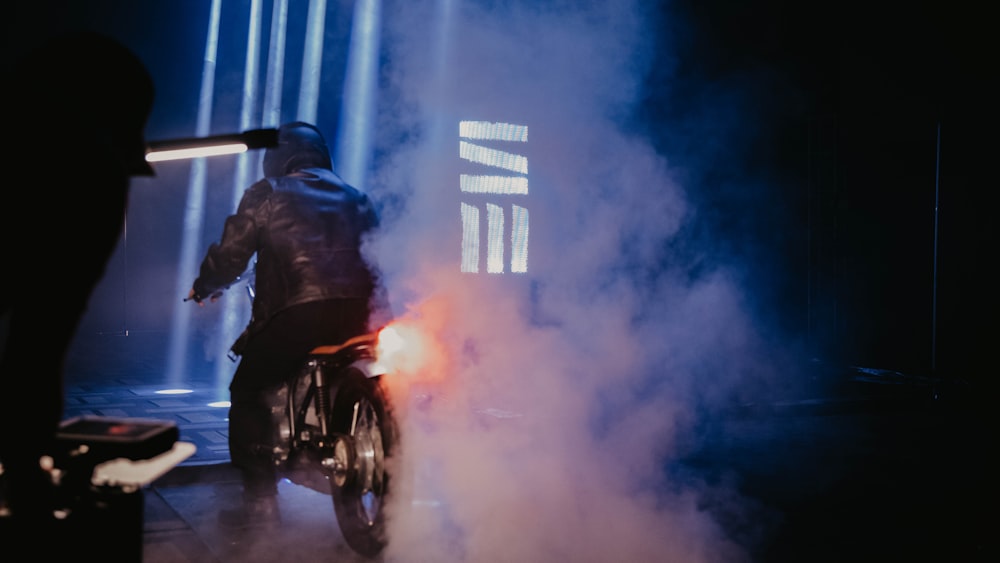 a man riding a motorcycle on top of a stage