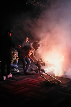 a group of people standing around a fire
