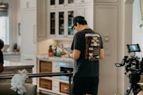 Male British professional ordering food via voice command on life butler app in a modern kitchen