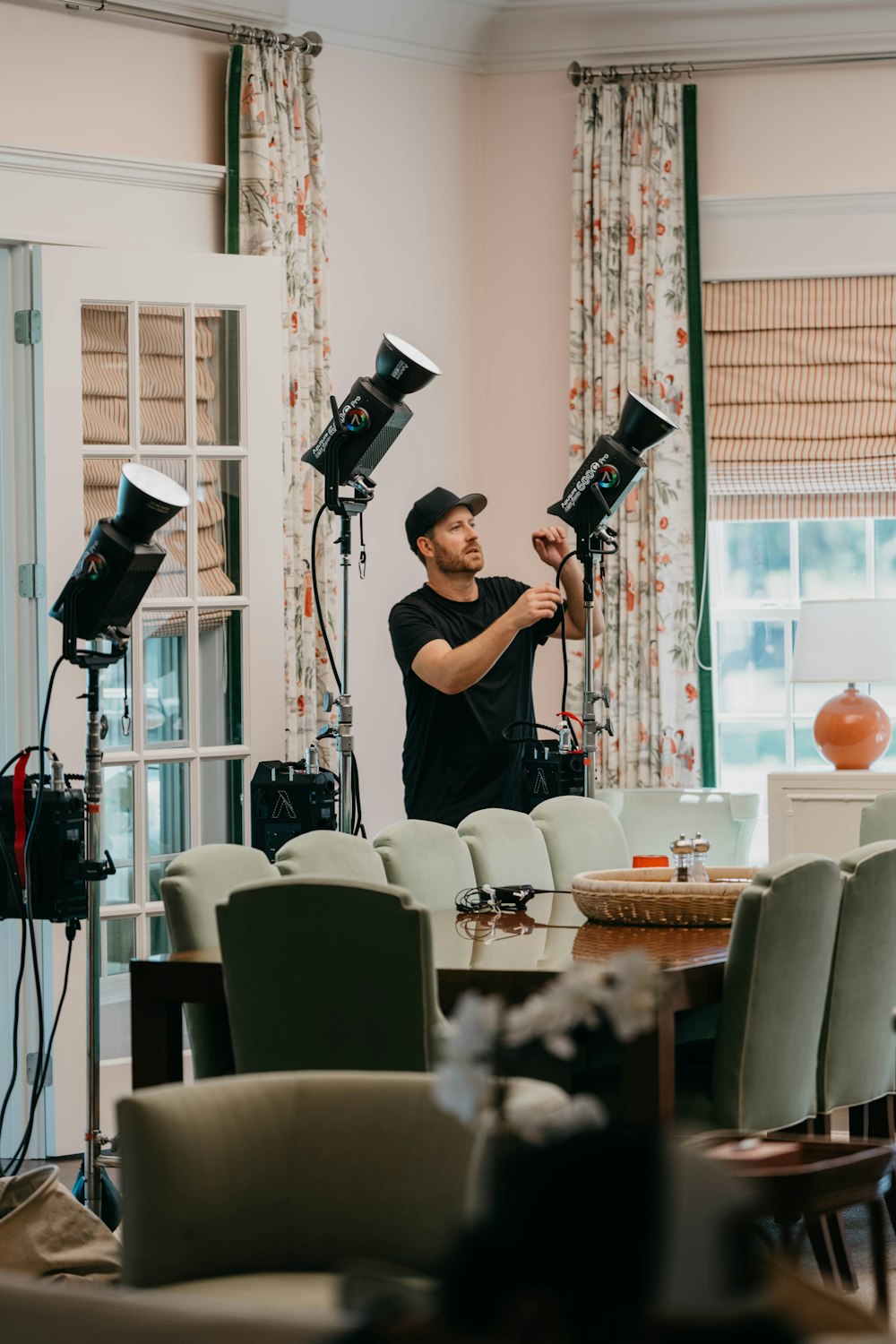 a man standing in a living room holding a camera