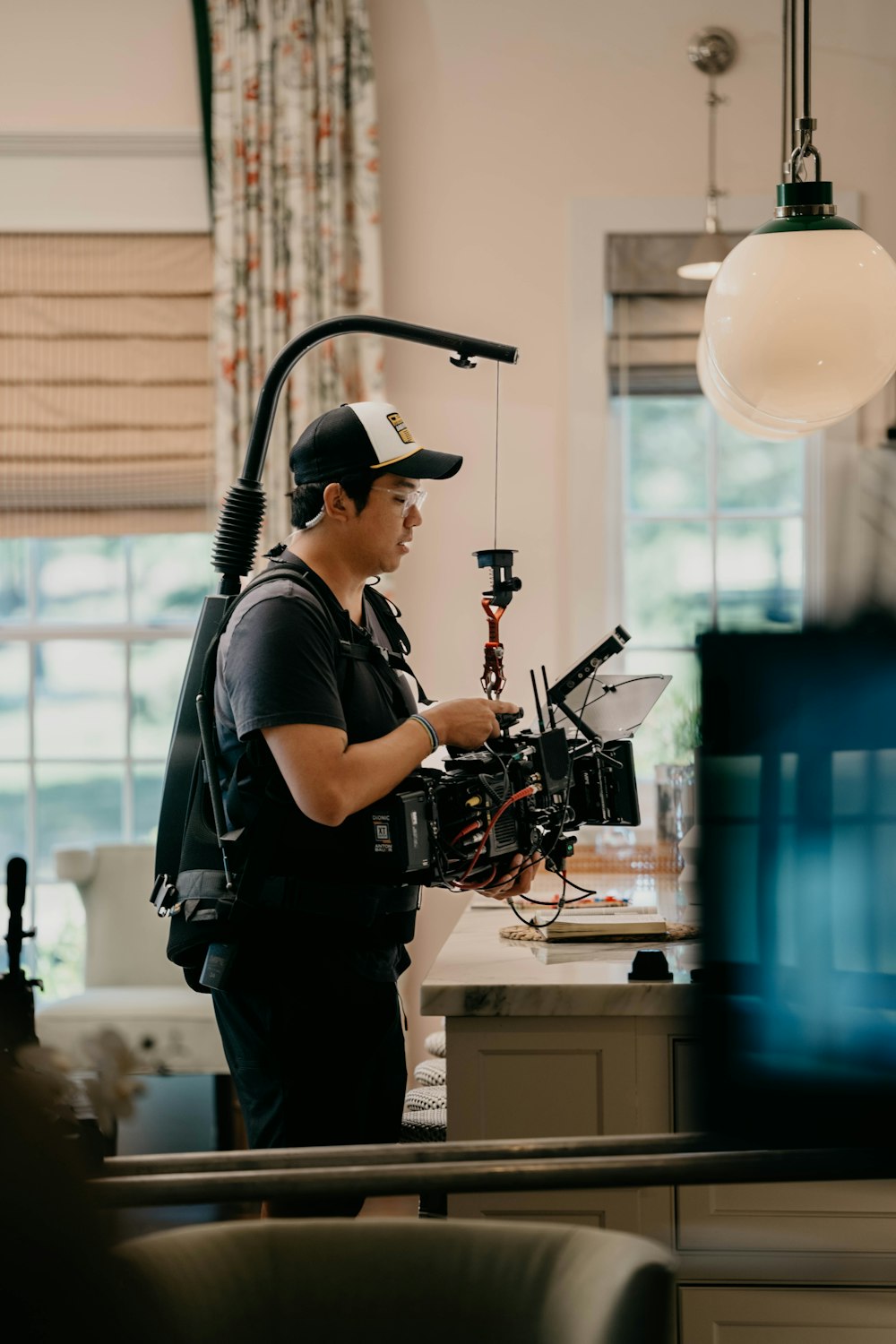 a man standing in a kitchen holding a camera